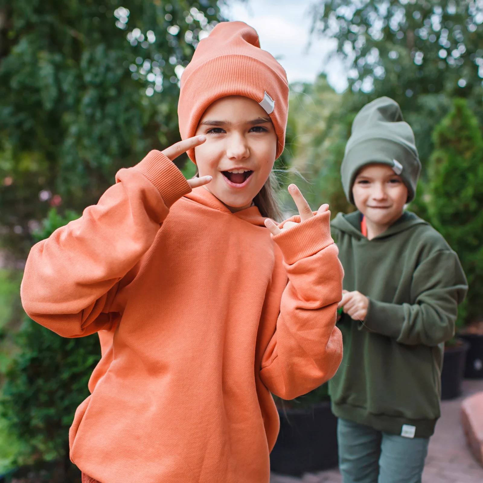 Children wearing hoodies from the source apparel collection